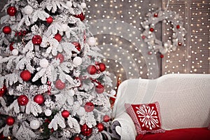 Snowy Christmas tree with red gifts decoration and comfy sofa be