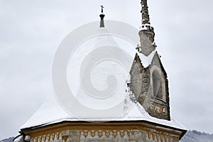 Snowy church roof with tower