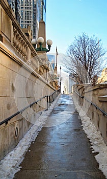 Snowy footpath leading up and away from the riverwalk in downtown Chicago Loop photo