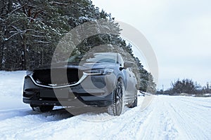Snowy country road with car