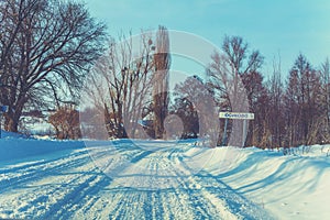 Snowy country road in winter sunny day