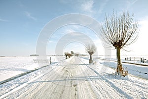 Snowy countryroad, in the Netherlands photo