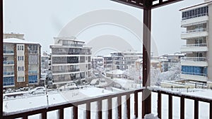 Snowy day in Denizli, Turkey, showcasing houses and traffic on the road