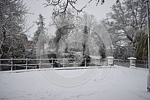 Snowy day in Leamington Spa UK, view of the small bridge over Leam River, Pump Room Gardens - 10 december 2017