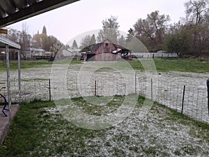 Snowy day overseeing big red barn