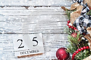 Snowy December 25th Calendar Blocks against White Rustic Background