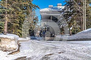 Snowy driveway in front of home in Park City Utah viewed on a sunny winter day