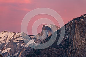 Snowy Half Dome bathed in a winter sunset.