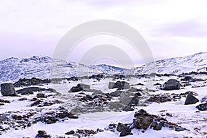 Snowy highland plateau with granite boulders