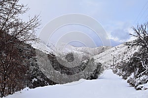 Snowy Hiking Trail views towards Lake Mountains Peak via Israel Canyon road towards Radio Towers in winter, Utah Lake, Wasatch Fro