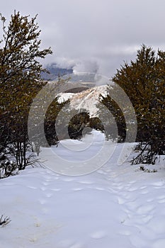 Snowy Hiking Trail views towards Lake Mountains Peak via Israel Canyon road towards Radio Towers in winter, Utah Lake, Wasatch Fro