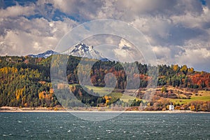 A snowy hill called Choc over The Liptovska Mara dam in autumn