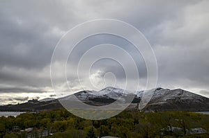 Snowy hills and city on the peninsula of the lake Sevan from Sevanavank monastery, Armenia