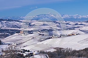 Snowy hilly landscape on the vineyards of the Langhe in the Unesco territory of Italy