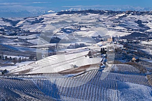 Snowy hilly landscape on the vineyards of the Langhe in the Unesco territory of Italy