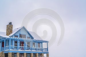 Snowy home with balcony against sky in Daybreak UT