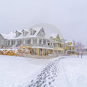 Snowy homes and footprints on snow in Daybreak