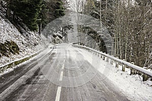 A snowy and icy road in the mountains