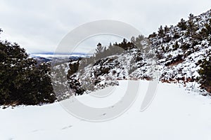 Snowy landscape with footsteps on the snow of the mountain road in Siete Aguas, Valencia