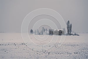 Snowy landscape with an old uninhabited country house