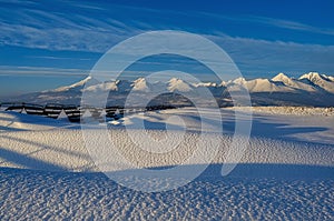 Snowy landscape with snow barriers at sunset