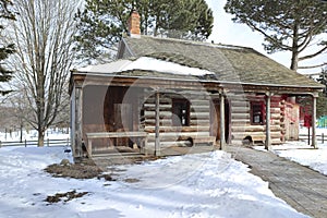 Snowy log cabin in the public park