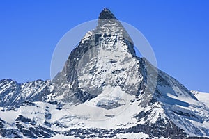 Snowy Matterhorn peak in sunny day with blue sky , Switzerland