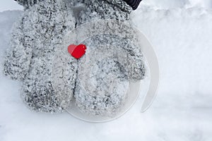 Snowy mittens with tiny red heart