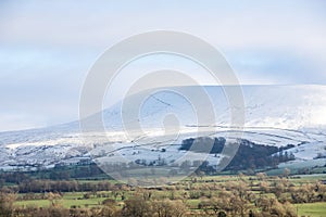 Snowy mountain covered in fresh winter snow. View of Pendle hill in the ribble valley, lancashire
