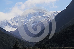 Snowy mountain enveloped in clouds