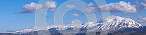 Snowy mountain with heavy clouds, panaromic view. photo