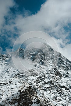 Snowy Mountain Himalayas peaks landscape of Moon Peak, Indarhar pass, Dhauladhar Range cloudy sky