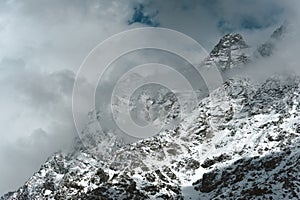 Snowy Mountain Himalayas peaks of Moon Peak, Indarhar pass, Dhauladhar Range cloudy sky