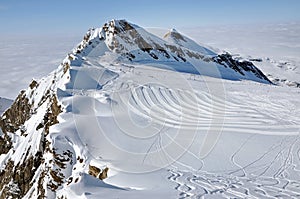 Snowy mountain landscape in sunny weather with ski piste