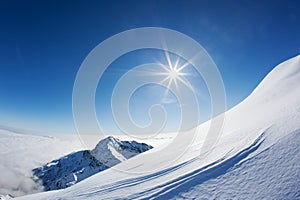 Snowy mountain landscape in a winter clear day.