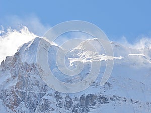 Snowy mountain peak full with snow landscape in clear blue sky