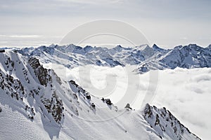 Snowy mountain peaks above the clouds