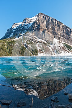 Snowy mountain reflection on lake Louise - Banff , Alberta, Cana