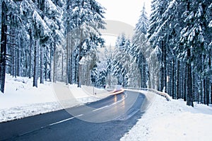 Snowy mountain road. Winter forest landscape.