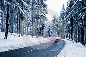 Snowy mountain road. Winter forest landscape.