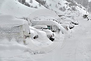 Snowy mountain skiing village, falling snow