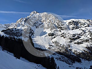 snowy mountain in switzerland shines through the first rays of sunshine