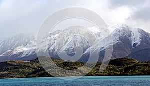 Snowy Mountain towering over lake wanaka New Zealand