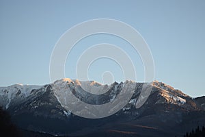 Snowy mountain under the plain blue sky