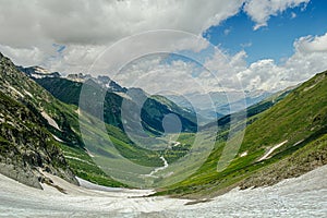 snowy mountain valley with blue sky