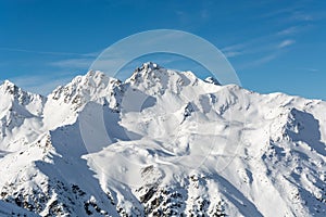 Snowy mountains in the Austrian alps with blue sky