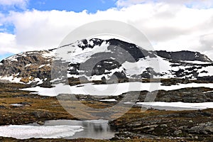 Snowy mountains with cloudy sky, natural park