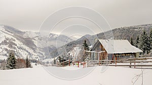 Snowy mountains and a cottage on top