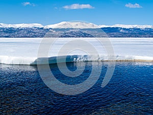 Snowy Mountains at frozen Lake Laberge, Canada