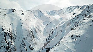 Snowy mountains of Kazakhstan. Opens the view of the gorge, ate growing on the hills and the top of the mountain.